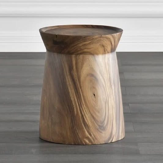 Solid wood stool with natural walnut grain, displayed on a gray wooden floor.